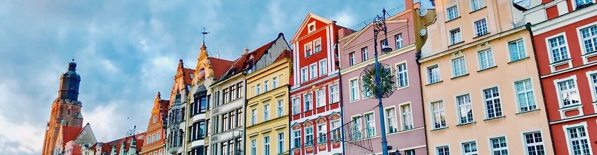 Wrocław night skyline with parked cars
