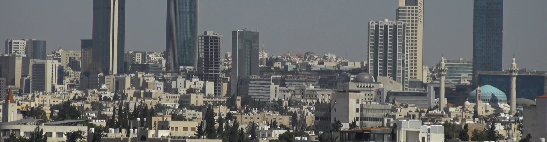 Amman night skyline with parked cars