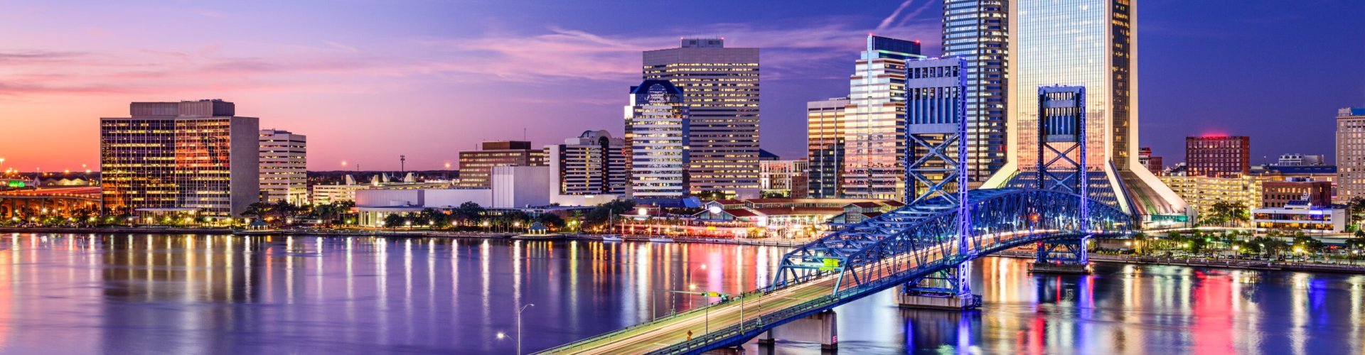Jacksonville night skyline with parked cars