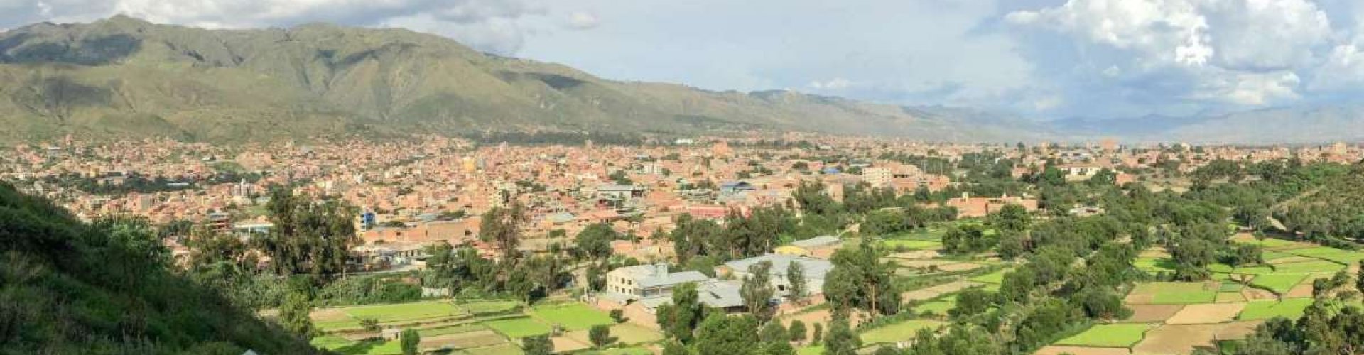 Cochabamba night skyline with parked cars