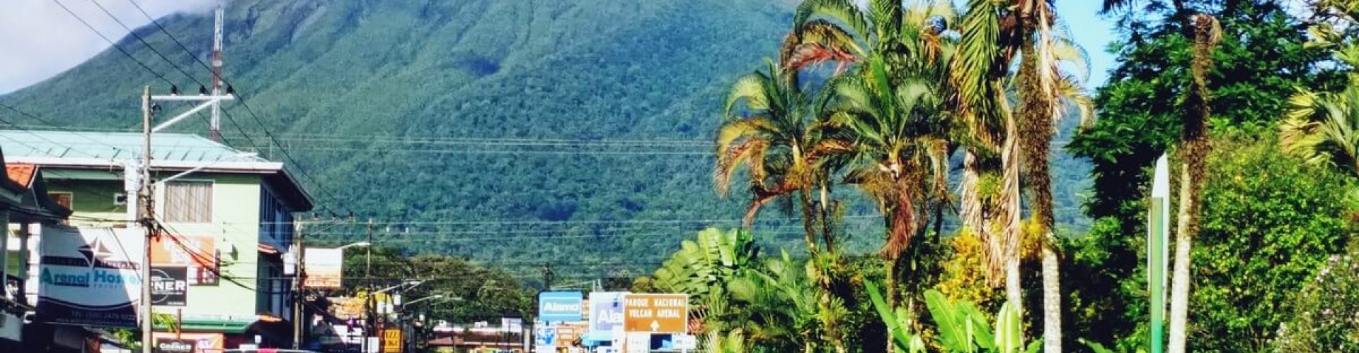 La Fortuna night skyline with parked cars