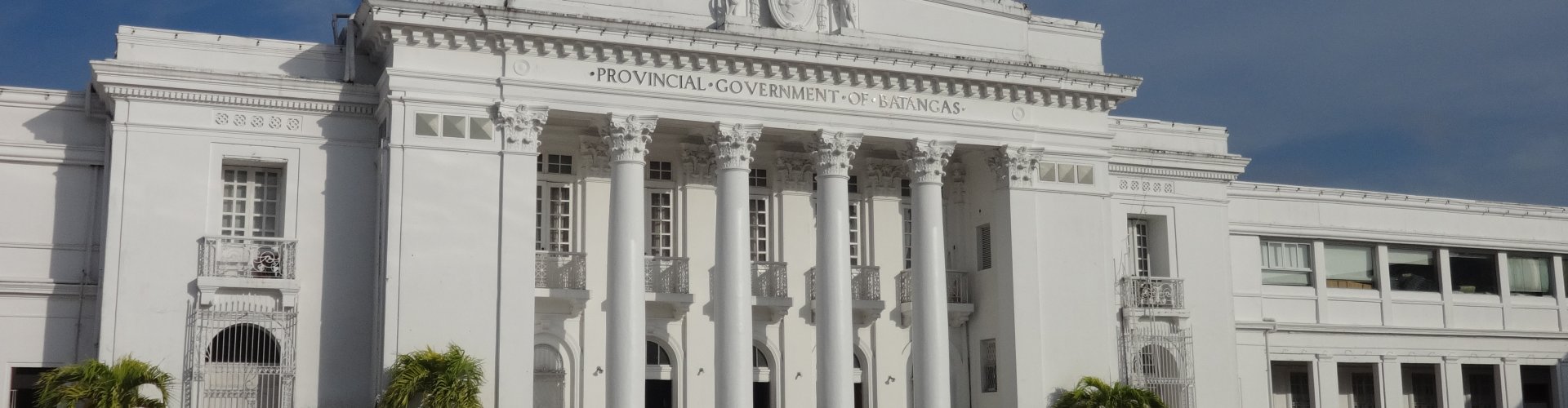 Batangas City night skyline with parked cars