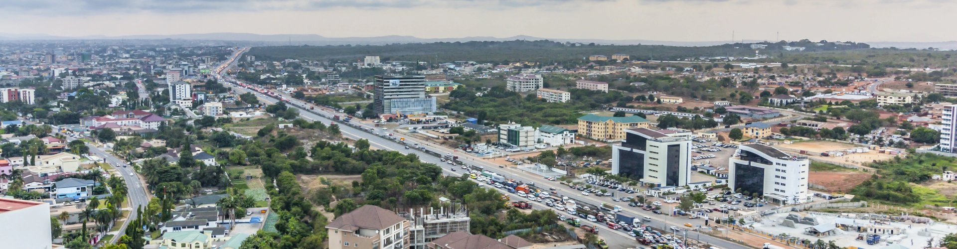 Accra night skyline with parked cars