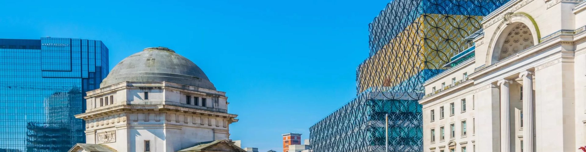 Birmingham night skyline with parked cars